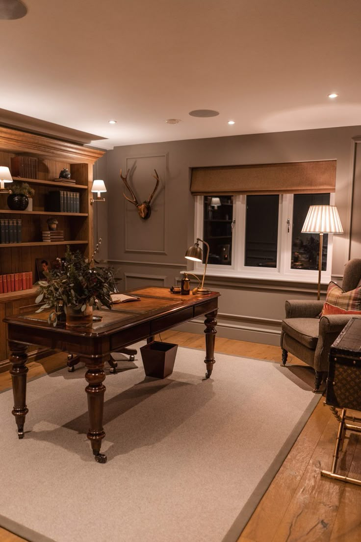 a living room filled with furniture and a large wooden table in front of a window