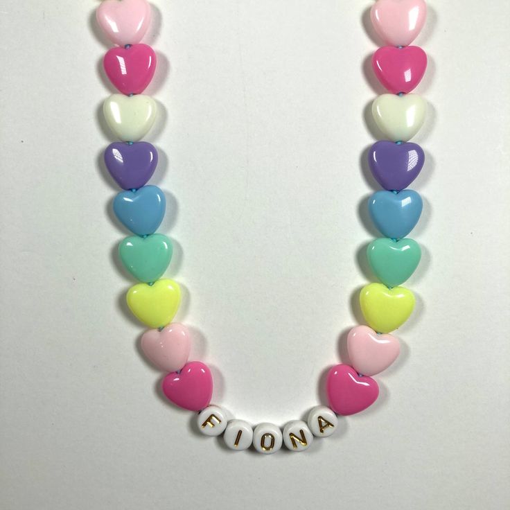 "You have just found the perfect gift for birthdays or Easter! This cute pastel, retro HEART necklace can come personalized or with hearts only. This 16\" stretchy necklace fits right over your head so it's easy to put on- no clasps needed. The matching bracelet is listed here: https://www.etsy.com/listing/909362079/kids-heart-bracelet-party-favor-girls?ref=shop_home_active_5&frs=1 Please check all selections and spelling prior to check out. Our custom jewelry is made to order so all sales a White Heart Necklace With Charm For Birthday, Cute Pink Heart Necklace For Mother's Day, Pink Heart Necklace For Birthday And Mother's Day, White Heart Charm Necklace For Birthday, Cute Personalized Necklaces, Cute Multicolor Necklace For Birthday, Pink Heart Necklace For Birthday, Pink Necklace With Heart Charm For Birthday, White Heart Necklace For Birthday