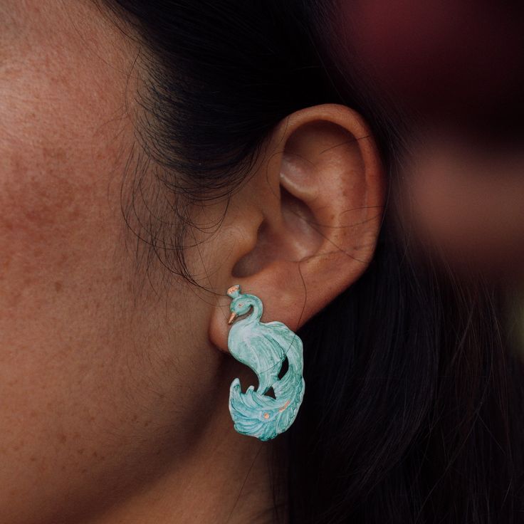 Poised peacocks proudly trail their plumage in this hand-painted pair. Brass with sterling silver posts. Nickel and lead free. 1.5" [3.5 cm] long. Gold Bamboo Earrings, Laura Park, Constellation Earrings, Orchid Earrings, Galaxy Earrings, Hair Necklace, Butterfly Earrings Gold, Bali Earrings, Peacock Earrings