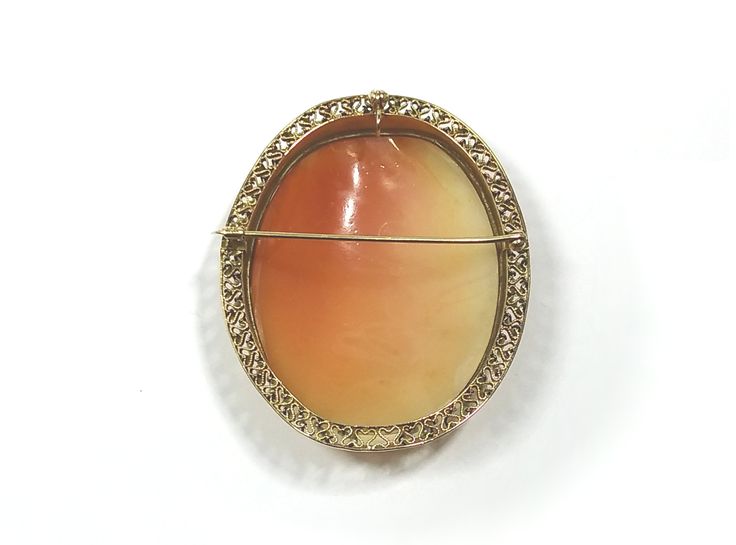 Item: Brooch/Pendant Circa: 1837 - 1901, probably The Romantic Period (1837-1860) Cameo Material: Carnelian Shell Decorative Material: Natural Seed Pearls on border of tiny filigree hearts. Metal: 14 kt Yellow Gold, Marked Size (Approximate): Oval Bezel 2.1875 inches long x 1.75 inch; Carnelian shell Cameo: 2.125 inches x 1.5 inches Weight: 21.93 grams Condition: Overall condition is excellent with no apparent damage. The bail, pin and clasp work properly. The tip of the pin which extends beyond Oval Fine Jewelry Brooches As Gift, Oval Brooch In Fine Jewelry Style For Formal Occasions, Oval Fine Jewelry Brooch For Gift, Fine Jewelry Brooch, Heirloom Style Collectible Jewelry With Brooch, Carved Oval Brooch For Formal Wear, Carved Yellow Gold Brooches For Wedding, Collectible Fine Jewelry Brooch, Oval Cabochon Brooches For Anniversary