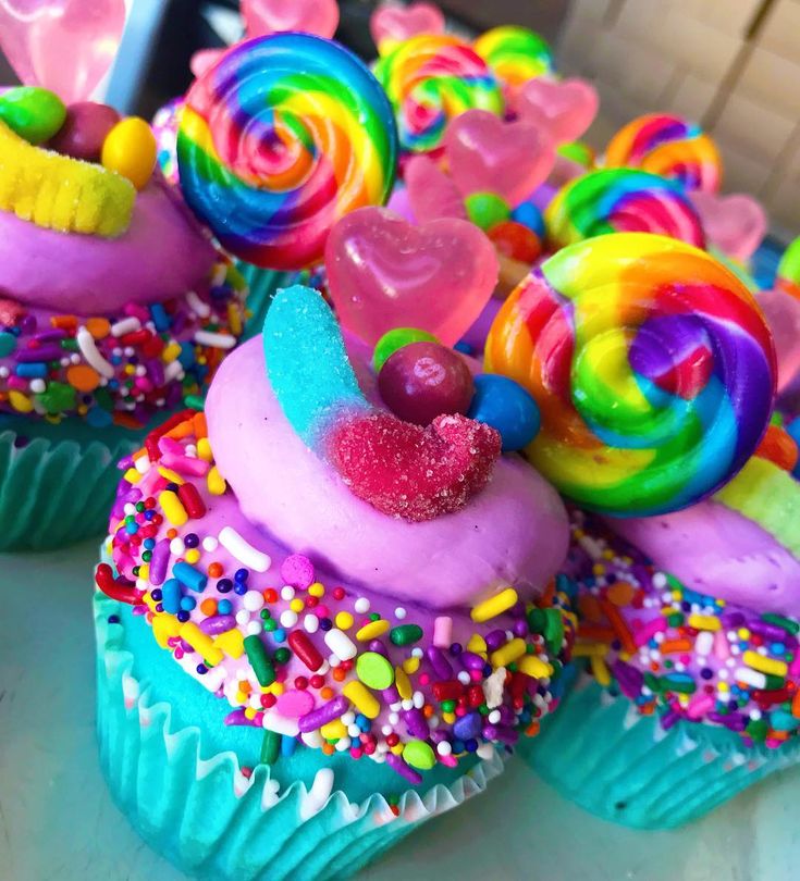 colorful cupcakes with candy and candies on them