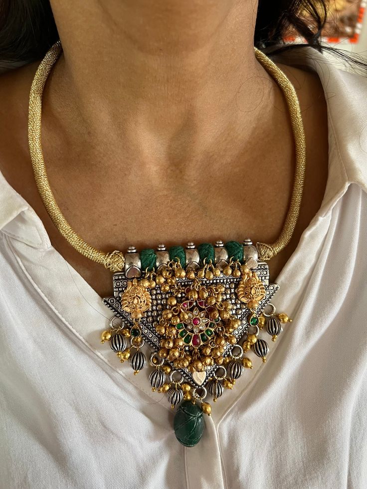 SHIVKA SPECIAL  New Arrivals ♥️ All our pieces are in stock and will be dispatched with in 24 to 48 hours of order. Orders received during the weekend will be dispatched on Monday.  One of our favorite picks for the wedding season ❤️ Materials: Carved Stones, Ghungroo, Mini Pearls, Dual tone plating. Dimensions Weight of the necklace: 100 grams Drop Length of the necklace: 9 inches Height of pendant: 4 inches Width of pendant: 3.5 inches Weight of earrings is 12 g per pair. Drop Length of earrings: 5.5 cms, Push back closure. The necklace comes with Dori and adjustable. Fusion Style Gold Jewelry Sets With Pendant, Fusion Style Jewelry Sets With Pendant For Celebration, Fusion Style Pendant Jewelry Sets For Celebration, Fusion Style Jewelry For Wedding And Navratri, Festive Fusion Style Jewelry Sets, Traditional Wedding Jewelry With Artistic Design, Green Fusion Bridal Necklace With Intricate Design, Green Fusion Temple Necklace For Celebrations, Handmade Gold Fusion Jewelry Sets