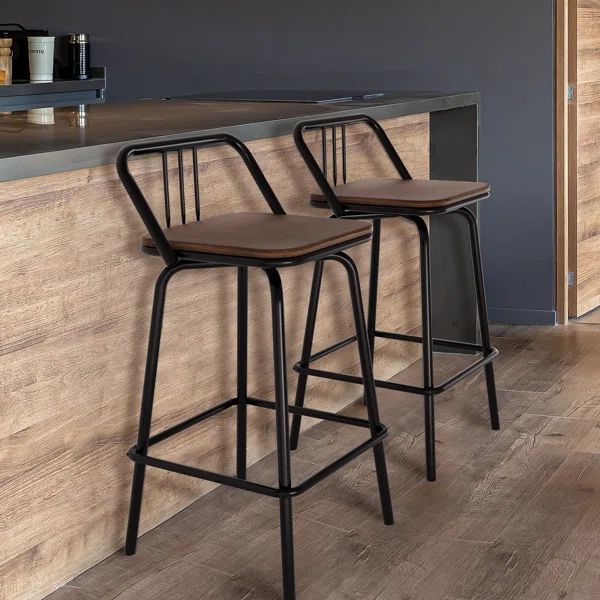 two wooden barstools sitting next to each other in front of a kitchen counter