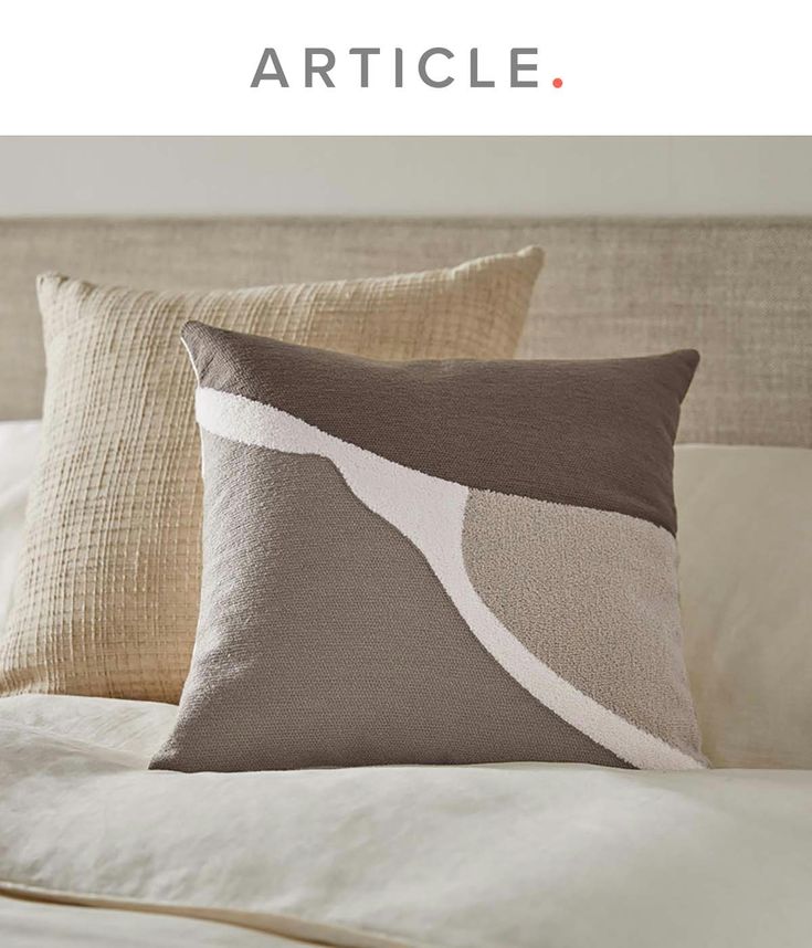 a bed with two pillows on top of it and the words article written in white