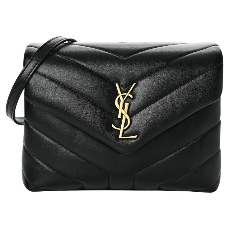 This shoulder bag is made of smooth calfskin leather in black. The bag features signature Y quilting, the brand monogram at front, a crossbody strap, aged gold hardware, a front flap and an interior of black fabric with multi compartments and a patch/zip pockets. Color: Black with gold hardware Material: Calfskin leather Size: Toy size Measures: Height 5.25” x Length 7.25” x Depth 2.75” Drop: 20.25 in Comes With: Dust bag & Strap. Authentication From Vault Concept Style code: 467072 Year 2020 Co Ysl Toy Loulou, Alber Elbaz, Lou Lou, Chevron Quilt, Classic Toys, Bag Straps, Fashion Handbags, Black Fabric, Purses Crossbody