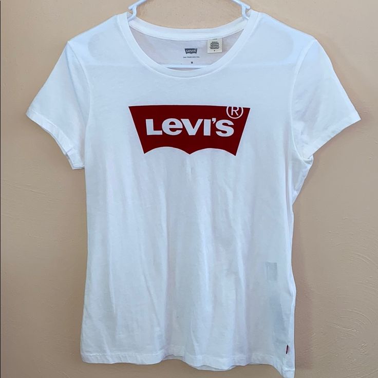 White Levi’s Tshirt; Never Worn But No Tags Levi's Red Crew Neck Top, Levi's Short Sleeve T-shirt For Spring, Levi's Basic Short Sleeve T-shirt, Levi's White Short Sleeve Shirt, Levi's White Relaxed Fit Shirt, Casual White Levi's Top, Levi's Short Sleeve T-shirt With Text Print, Levi's Short Sleeve Letter Print Tops, Levi's Short Sleeve T-shirt For Summer