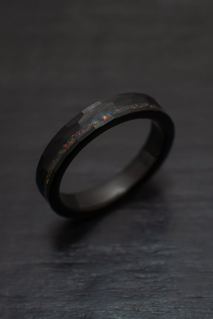 Our gorgeous 4mm Black Obsidian-style Hammered Tungsten Wedding Ring with an beautiful bello balck opal inlay. + Comes in a handmade wax-sealed Ring Box *Durable - Incredible Scratch Resistant Performance to always look great. *Comfort-fit & Weighty - Designed to fit well and feel good in your hand. *Made to order - Every ring we ship is unique and one-of-a-kind. *4mm - Popular Standard width *Hypoallergenic - No discomfort from metals. *Cobalt-Free - Will never turn your finger green or irr Men’s Engagement Rings Black, Male Wedding Bands Tungsten, Wedding Ring No Diamond, Masc Ring, Masc Engagement Ring, Masc Rings, Black Wedding Bands For Men, Black Wedding Rings For Men, Black Ring Band