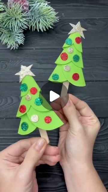 someone is making a christmas tree out of construction paper