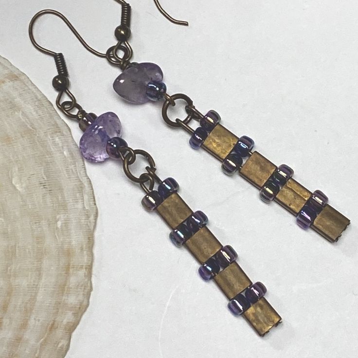 Contemporary Designed Earrings Feature Smooth Pebbles Of Genuine Amethyst & Bronze Colored Tila Beads Accented With Iridescent Rainbow Purple Glass Beads. They Have An Outer Space Look To Them . Lightweight & Comfy. Made & Designed By Me Nickel Free Ear Wires New, Never Worn Smoke Free, Pet Friendly Purple Bronze Contemporary Modern Design Genuine Amethyst Lavender Artisan Custom Earrings Long Funky Unique Ooak Trendy Hippie Boho Handmade Original Purple Dangle Beaded Earrings With Spacer Beads, Purple Bohemian Crystal Earrings As A Gift, Purple Bohemian Crystal Earrings For Gift, Handmade Bohemian Purple Crystal Earrings, Handmade Purple Bohemian Crystal Earrings, Nickel-free Purple Beaded Earrings With Round Beads, Nickel-free Purple Beaded Earrings, Adjustable Purple Metal Earrings, Purple Metal Crystal Earrings As Gift