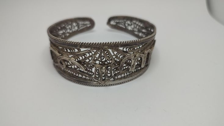 Beautiful antique bracelet made by sterling silver worked in filigree tehnique, no hallmarks, been tested with acid for silver,with time patina In great condition Weight 30grams All of our pieces are in pre-loved, vintage or antique condition, with signs of age and wear preserved as a mark of authenticity. Ornate Hallmarked Cuff Bracelet For Ceremonial Use, Ornate Hallmarked Cuff Bracelet For Ceremonial Occasions, Ornate Ceremonial Cuff Bracelet Hallmarked, Ornate Ceremonial Cuff Bracelet With Hallmark, Traditional Filigree Cuff Bracelet Bangle, Traditional Filigree Cuff Bangle Bracelet, Unique Silver Filigree Cuff Bracelet, Unique Silver Filigree Bracelet, Handmade Ornate Cuff Bracelet