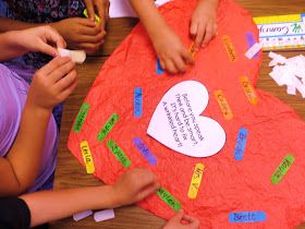 children are making a heart shaped paper craft