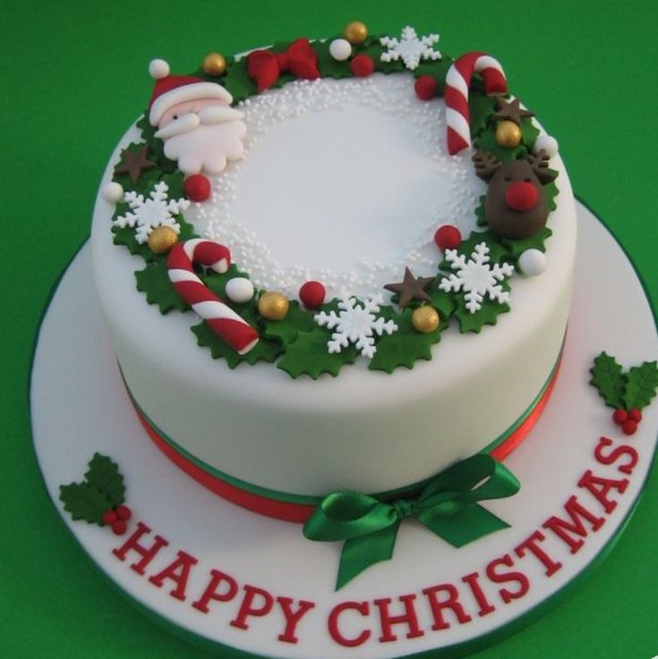 a decorated christmas cake on a green table