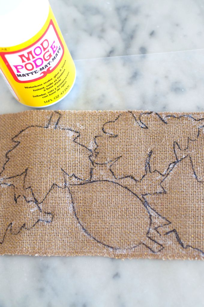 a close up of a piece of burlock on a table next to a bottle of glue