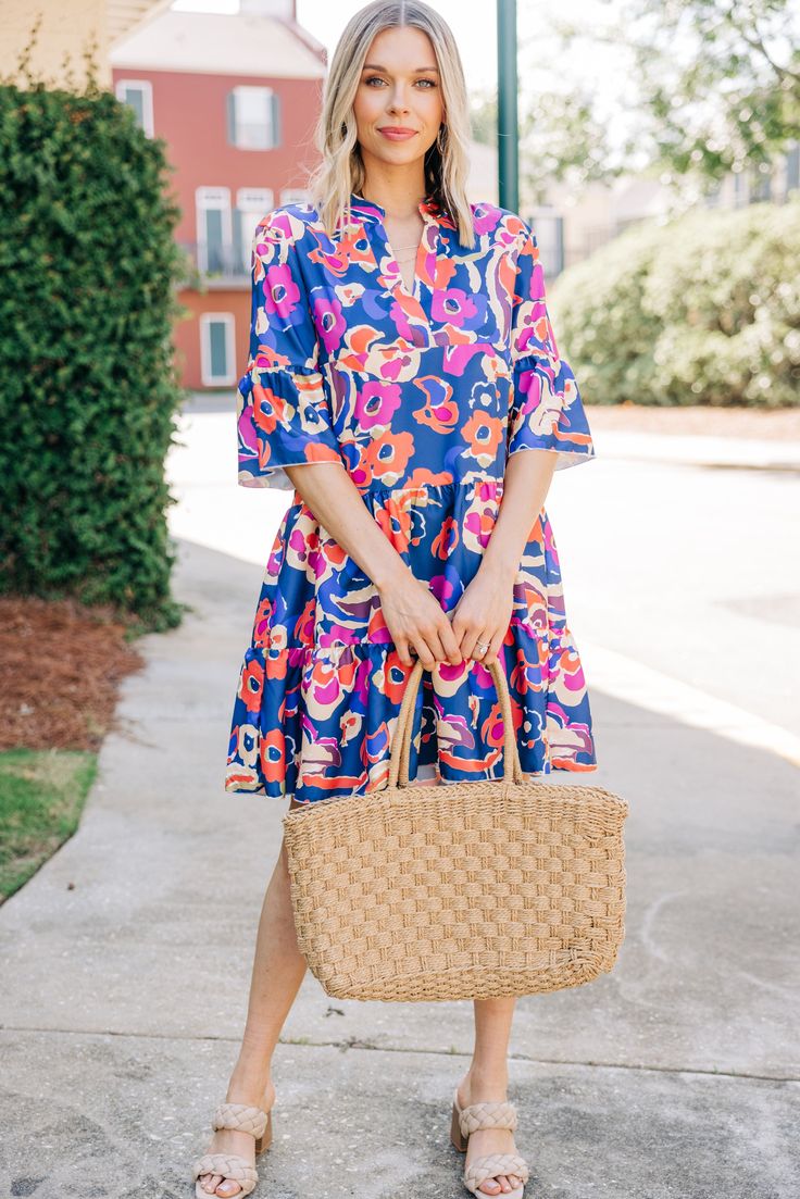 This dress just feels like love! That floral print is so pretty and we love how bold it is! This tiered dress is so chic and is going to look fabulous on you! It's going to be perfect for date nights, a day at the office, or anything in between! This dress features a split v-neck, short sleeves with a peplum detail, a tiered body, and bold floral print. Material has no amount of stretch.Cam is wearing the small. Blue Bold Print Dress For Vacation, Blue Dress With Bold Print For Vacation, Blue Summer Dress With Bold Print, Summer Blue Dress With Bold Print, Blue Bold Print Summer Dress, Spring Midi Dress With Bold Print, Multicolor Tiered Floral Dress For Vacation, Blue Tiered Dress For Summer Day Out, Chic Blue Printed Floral Dress