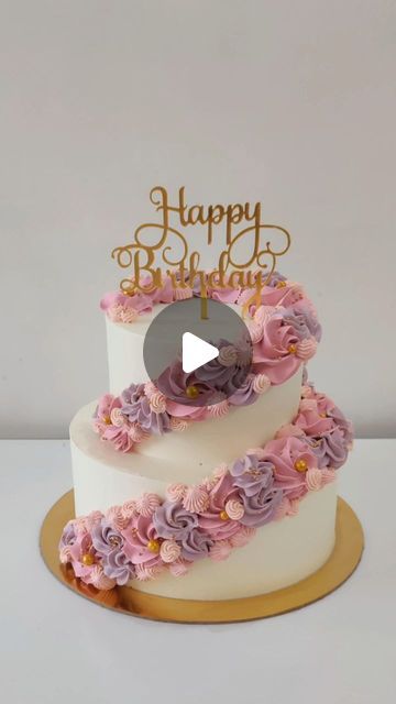 a three tiered cake decorated with pink and purple flowers