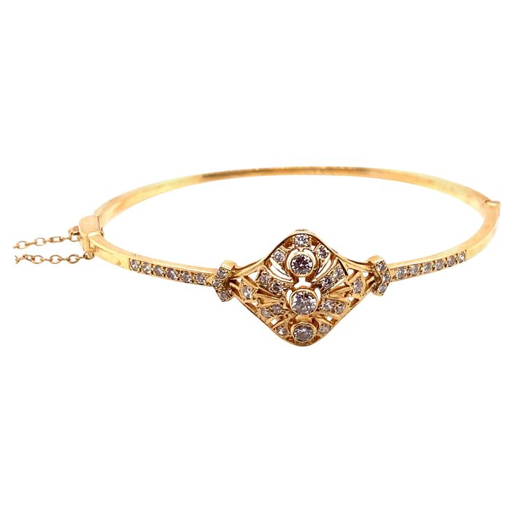 Vintage Victorian Era Reproduction 14K Yellow Gold Diamond Bangle - The bangle contains 38 round brilliant diamonds weighing approximately 1.00ct with G - H color and SI clarity. The width of the bangle in the center measures 16.5mm, and the rest of the bangle measures 2.4mm. The inside diameter is 2 inches high by 2.5 inches wide. The bangle weighs 12.85 grams. Luxury Ornate Gold Bangle Bracelet, Luxury Antique Oval Gold Bracelet, Luxury Vintage Adjustable Bangle, Luxury Victorian Hallmarked Gold Bracelet, Luxury Yellow Gold Victorian Bracelet, Diamond Bangle, Vintage Victorian, Brilliant Diamond, Victorian Era