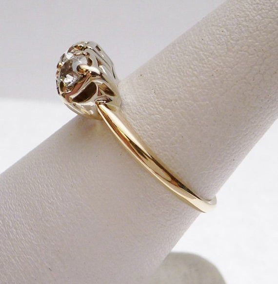 a close up of a gold ring on a white surface