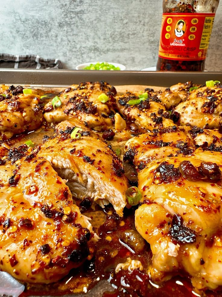 the chicken is covered in sauce and ready to be cooked on the grill or oven