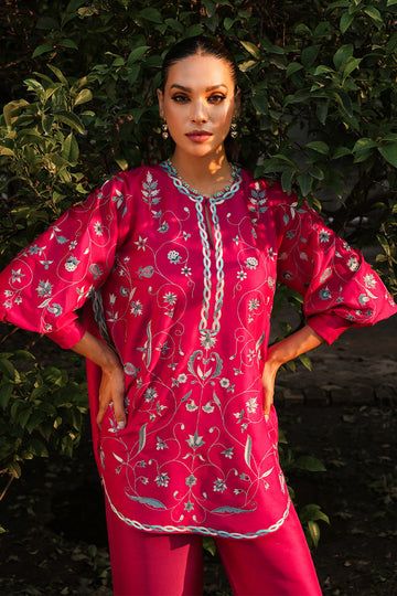 We continue to infuse extra love in effortless ensembles that become perfect partners for your casual and formal gatherings. The cherry pink pure rawsilk shirt is adorned with delicate floral embroidery taking the mood from pretty to playful with its exaggerated cuff sleeves and pure rawsilk trousers with an embroidere