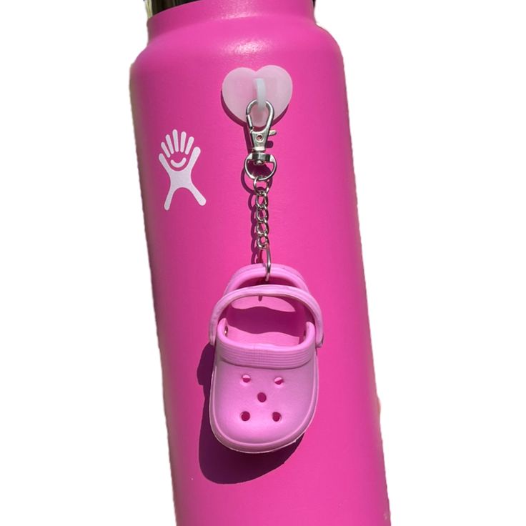 a pink water bottle with a key chain attached to it