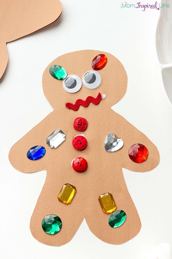 a paper cut out of a ginger with buttons on it and other crafting supplies