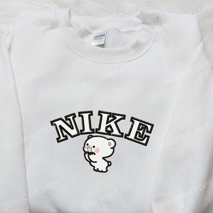 Milk Bear x Nike Cartoon Embroidered Shirt, Nike Inspired Embroidered T-shirt, Best Gift Ideas for Family Step into the enchanting world of Tinicloset, a haven where creativity and cuteness collide to craft a unique array of custom embroidered garments that will warm your heart. From the irresistibly adorable Milk Bear x Nike Cartoon embroidered shirt... Casual Embroidered Crew T-shirt, Embroidered Cotton Crew T-shirt, Embroidered Cotton Crew Top, White Casual Tops With Custom Embroidery, White Casual Top With Custom Embroidery, Cute Long Sleeve T-shirt With Embroidered Text, White Crew Neck Top With Embroidered Graphics, White Embroidered Crew Neck Top, White Long Sleeve T-shirt With Embroidered Logo