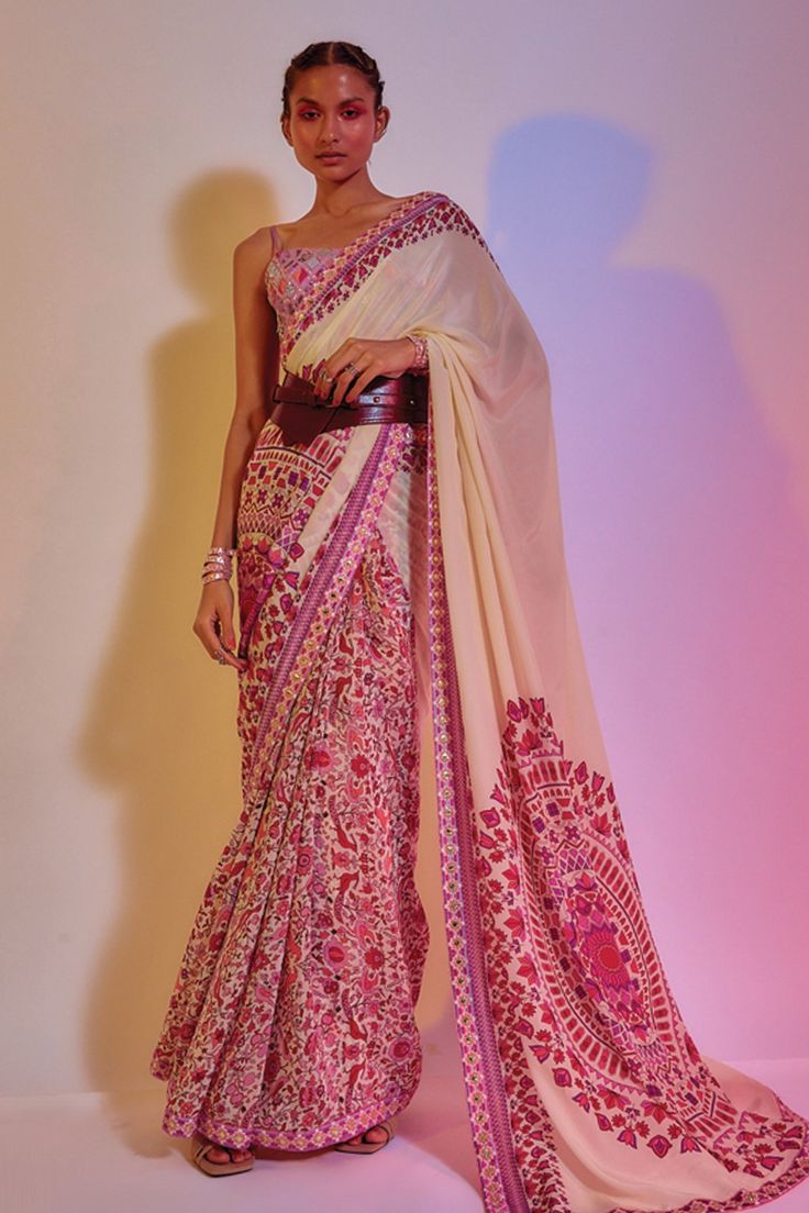 Ivory saree with floral printed motifs and embellished border. Comes with lilac embroidered blouse.
Component: 2
Pattern: Print and Embellishment
Type Of Work: Floral Print and Geometric Motifs
Neckline: Round
Sleeve Type: Sleeveless
Fabric: Crepe Silk and Silk
Color: White
Other Details: 
Note: Hand accessory and belt worn by the model is not for sale
Occasion: Destination Wedding - Aza Fashions Indian Fits, Embellished Saree, Silk Printed Saree, Character Wardrobe, Floral Saree, Royalty Aesthetic, Indian Dresses Traditional, Designer Outfits, Printed Saree