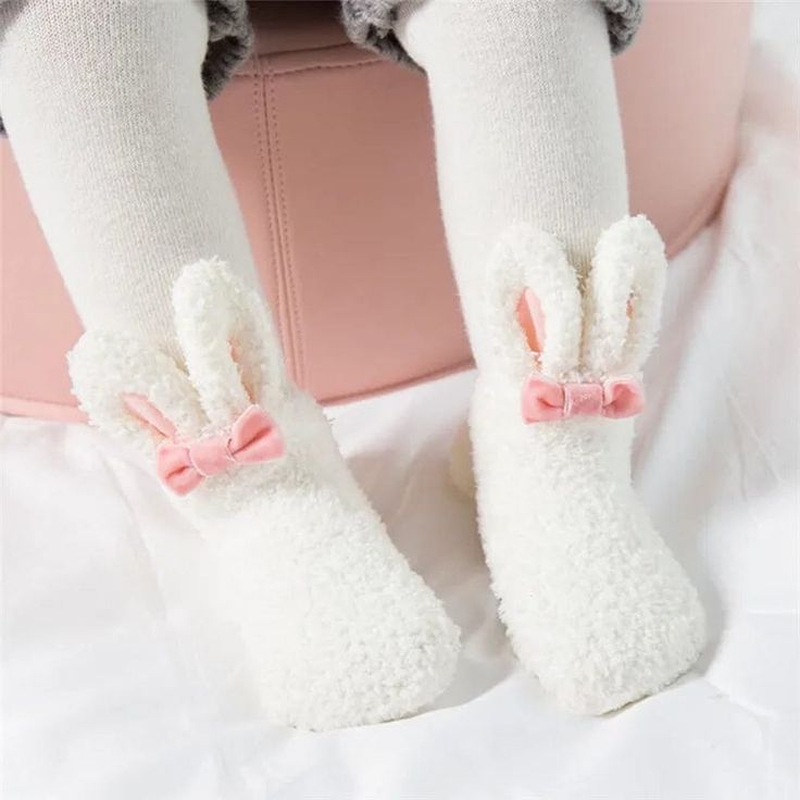 Embrace the coziness of winter with our adorable Bunny Baby Socks, designed to keep your little one's feet warm and stylish. Perfect for indoor lounging or outdoor adventures, these socks feature a soft, fluffy exterior and lining, ensuring maximum warmth and comfort. Adorned with a cute bunny face and ears on the top, a bow at the front, and playful pom poms, these socks are as charming as they are practical.Made with a cozy fleece material, these socks provide a soft and gentle touch against your baby's skin, keeping their feet warm and snug during the colder monthsThe socks boast a delightful bunny face and ears on the top, bringing a whimsical touch to your baby's winter wardrobe.A cute bow at the front and pom poms at the opening add playful elements to the socks, making them a joy to Bunny Ears And Tail, Vogue Kids, Fluffy Bunny, Toddler Socks, Rabbit Baby, Pink Socks, Bunny Face, Soft Cute