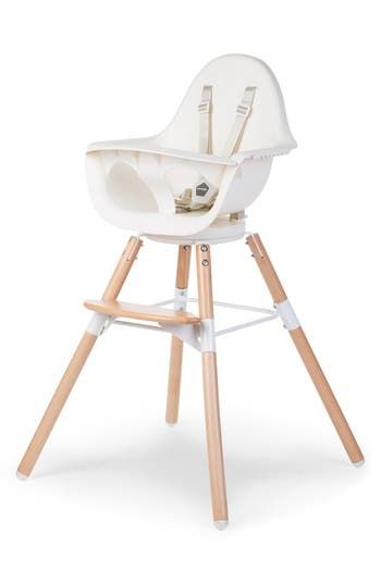 a white high chair with wooden legs and an infant seat in the middle, on a white background