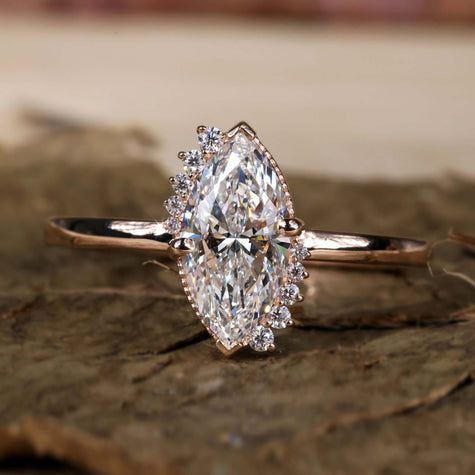 a diamond ring sitting on top of a piece of wood