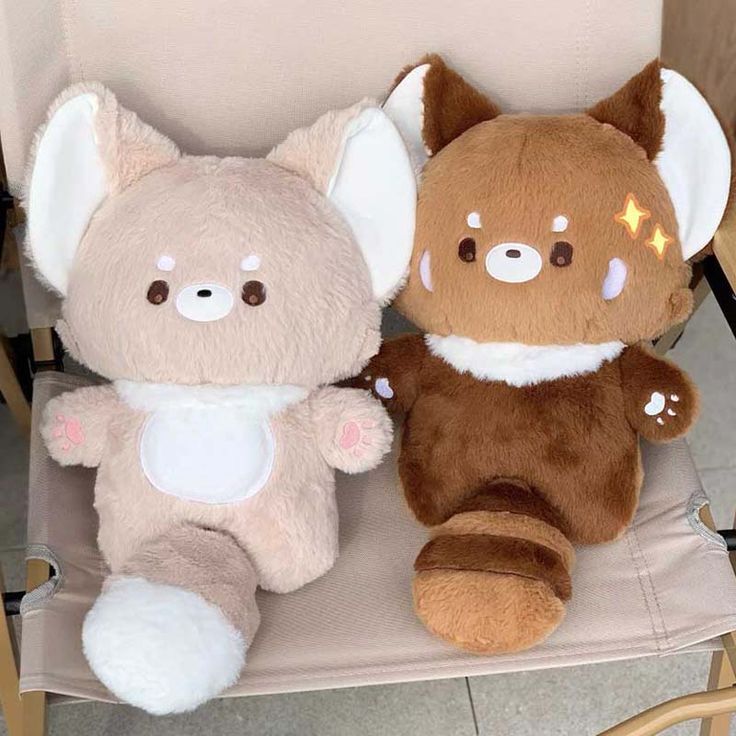 two stuffed animals are sitting on a chair