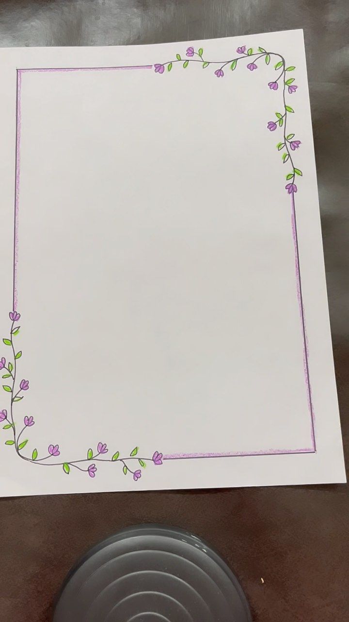 a white sheet of paper with purple flowers on it next to a potted plant