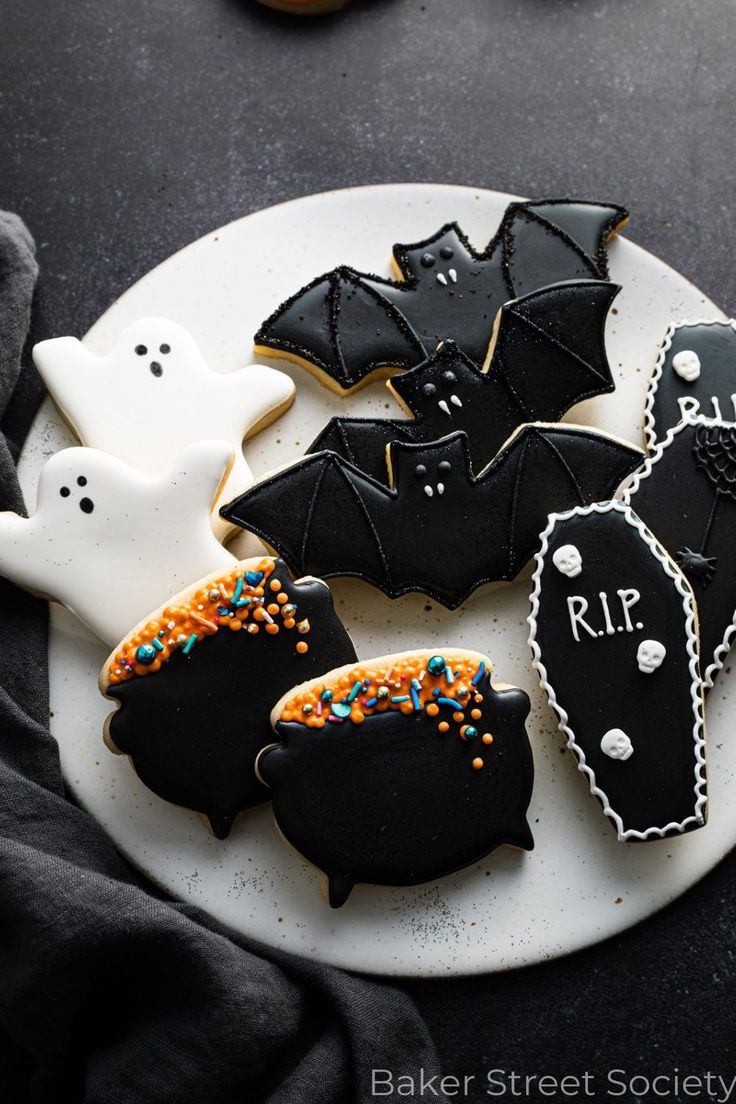 decorated halloween cookies on a white plate