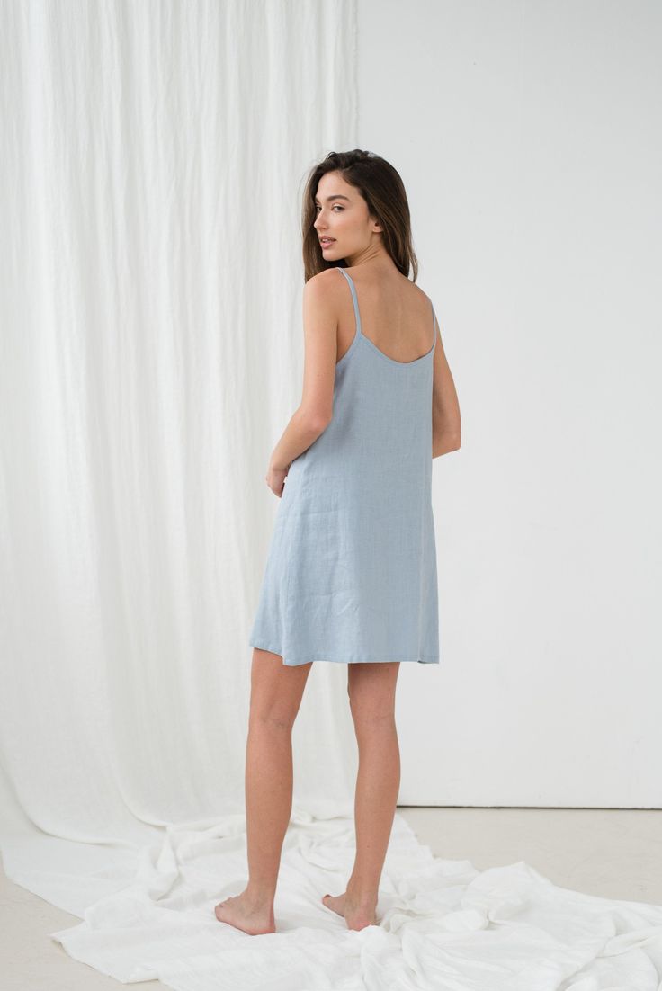 "Simple TILDA cami dress in light blue. - length is ± 92 cm (36.2\") (depends on size) - without pockets - relaxed fit DETAILS: - 100 % European, pre-washed medium weight linen (205 g/m²) - the model is 180 cm (5′11″) high, wearing size S. - model measurements: bust 84 cm (33\") / waist 61 cm (24\") / hips 92 cm (36\") - color in the picture - light blue (you can choose other color on the right) MADE TO ORDER: All pieces are made to order, it will take up to 10 work days to complete your order. Blue Slip Dress With Straight Neckline For Spring, Mini Linen Dress With Adjustable Straps, Light Blue Sundress With Adjustable Straps, Blue Spring Sleep Dress, Summer Linen Sleep Dress, Blue Linen Mini Dress For Vacation, Blue Summer Sleep Dress, Summer Mini Dress For Sleep, Blue Spaghetti Strap Loungewear Dress