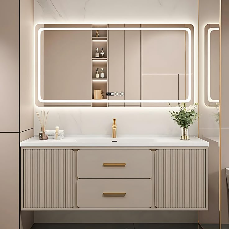 a bathroom with a large mirror above the sink and lights on the wall behind it