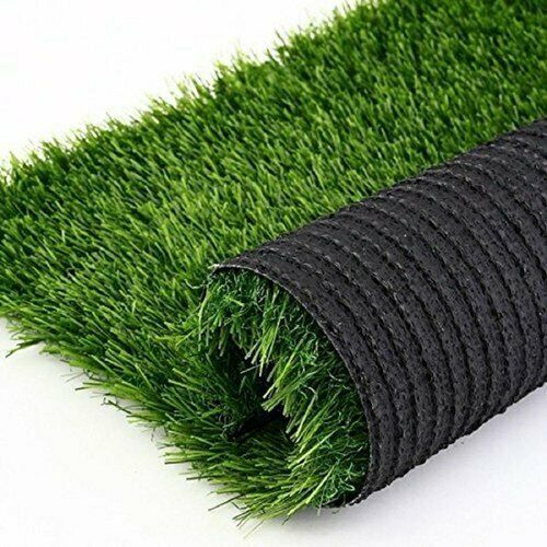 a roll of artificial grass laying on top of a white surface