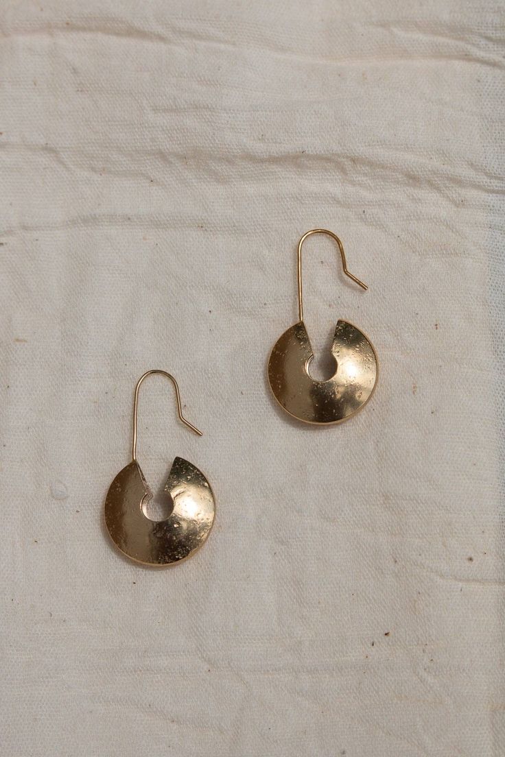 Inspired by West African culture, the 'Nkhando' Earrings (meaning 'Storage') offer a timeless design crafted with texture and bold dimension, making them an eye-catching piece. Made from brass coated in a luxuriously thick layer of 14k recycled gold with a unique texture, the Nkhando Earrings offer a versatile look for everyday wear, or for an elevated evening out. Pronounced 'Yay - Woh', YEWŌ Collective is a purpose-driven brand based in Malawi, Africa committed to creating growth, training, and employment opportunities for marginalized communities by designing and making elevated, timeless, and sustainable pieces that bring joy and authenticity to your everyday. Rooted in community, each piece of jewelry was intentionally designed and thoughtfully made at our solar-powered workshop in No Everyday Artisan Brass Jewelry, Artisan Gold Jewelry For Everyday, Pierced Round Earrings In Recycled Gold, Pierced Round Recycled Gold Earrings, Hand Forged Gold Artisan Earrings, Everyday Hand Forged Bronze Earrings, Artisan Yellow Gold Hammered Earrings, Artisan Yellow Gold Hand Forged Earrings, Artisan Hammered Yellow Gold Earrings