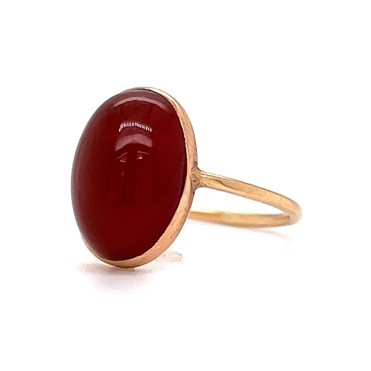 This stylish Victorian Bezel Set Carnelian Cocktail Ring features a cabochon cut red carnelian in polished 14 karat yellow gold. The center gemstone showcases a warm, crimson red hue. Set in a bezel on a dainty band. Perfect for signet ring & statement ring lovers. Timeless and chic. This antique cocktail ring would make a great gift for any loved one! Classic Yellow Gold Carnelian Jewelry, Classic Carnelian Yellow Gold Jewelry, Red Domed Rings For Anniversary, Red Domed Anniversary Ring, Classic Red Ruby Ring With Oval Cabochon, Formal Red Carnelian Signet Ring, Classic Red Ruby Ring, Oval Cabochon, Classic Round Carnelian Signet Ring, Classic Carnelian Round Signet Ring