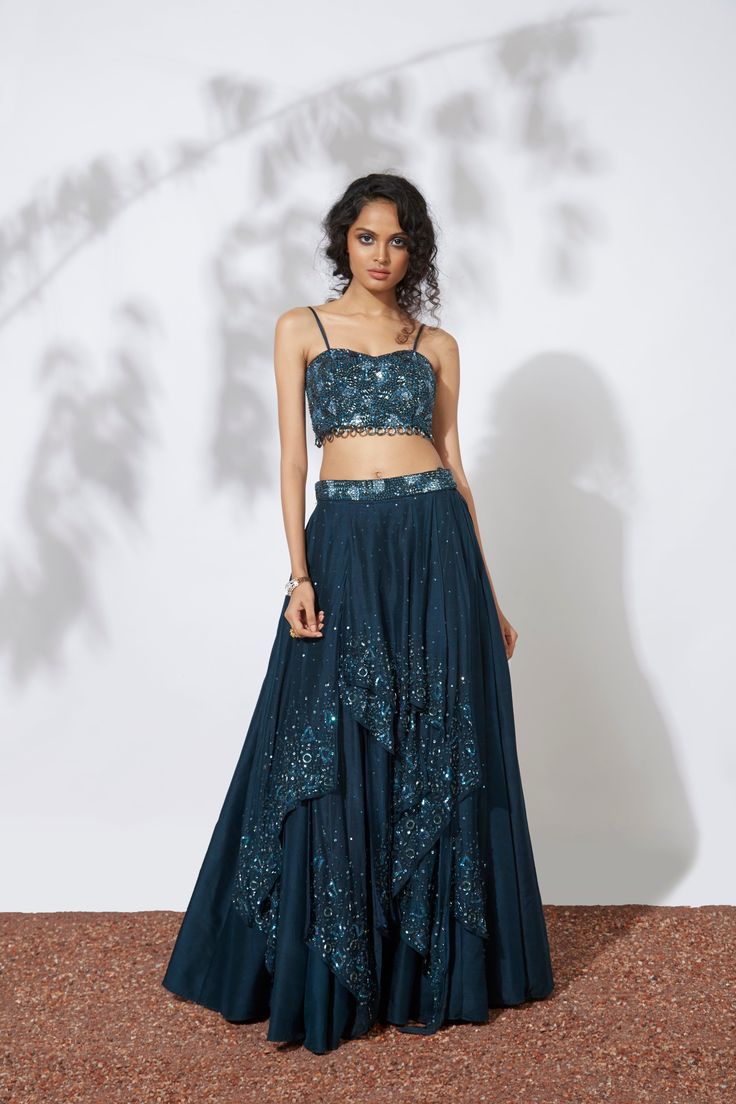 The Teal 32 Panels Lehenga and Bustier is exquisitely embroidered with intricate bead, tube, and sequin details, along with delicate ring detailing. Take your fashion game to the next level with this stunning set. Perfect for any special occasion, this outfit features intricate embroidery and stunning bead, tube, and sequin details. Plus, the delicate ring detailing adds a unique and playful touch. Get ready to turn heads and make a statement with this dazzling ensemble. Colour : TEAL Fabric : C Moon Skirt, Lehenga Crop Top, Midnight Moon, Crop Top Set, Teal Fabric, Intricate Embroidery, Delicate Rings, Embroidery Details, Fashion Games