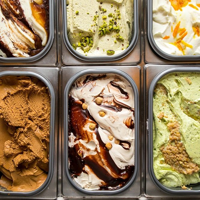 six containers filled with different types of ice cream