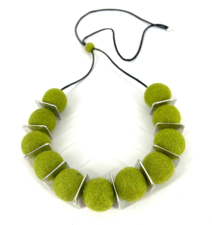 a necklace made out of green felt balls