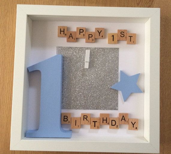 a photo frame with scrabbles and letters that spell out the word happy 1st birthday