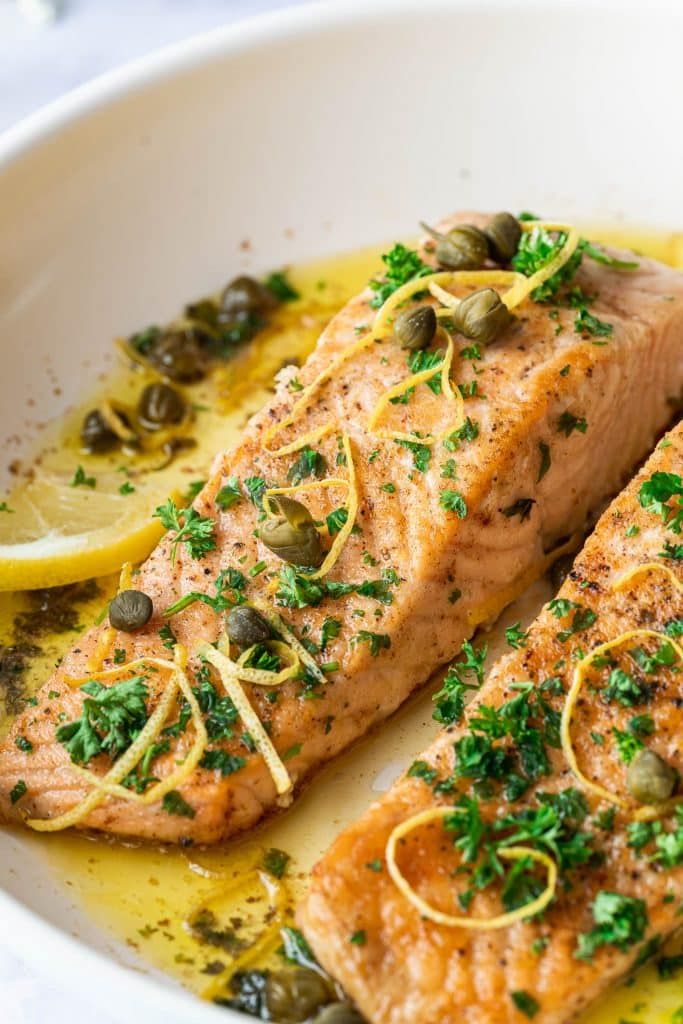 two salmons with lemon and capers in a white bowl