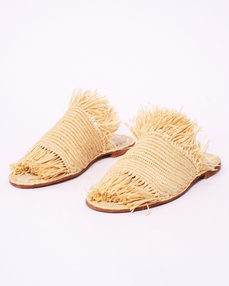 a pair of slippers with fringes on them