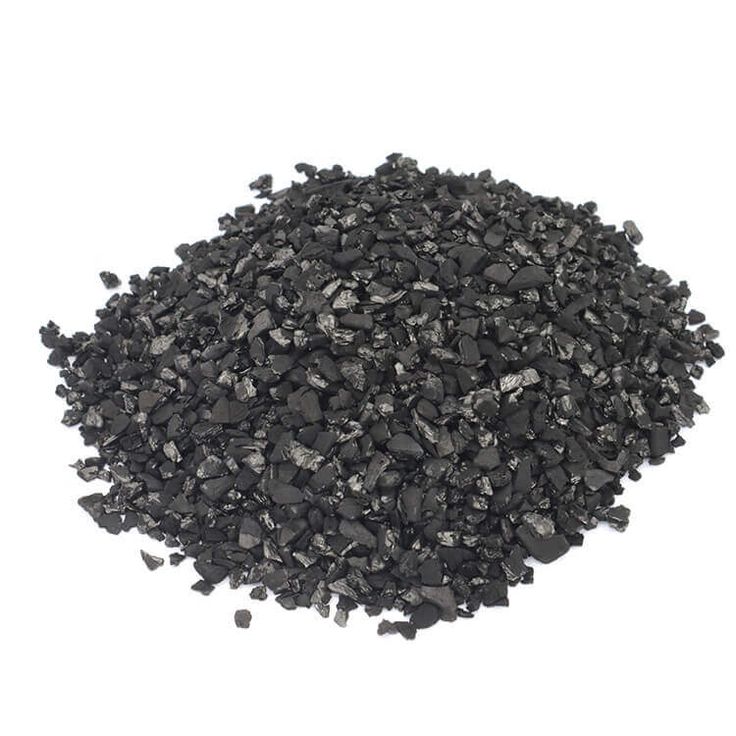 a pile of black coal sitting on top of a white surface