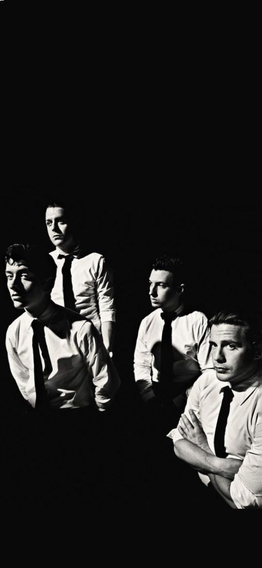 black and white photograph of four men wearing ties