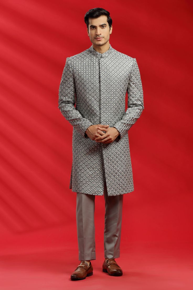 Top Details Color- GREY, Fabric - Suiting Fabric With Embroidered Bottom Details Color- Grey, Fabric -Suiting Fabric, Style - Pant Package Include :INCLUDES 1 SHERWANI,1 PANT. Turban ,Mojari And Other Accessories Are Not Sold Along With The Dress. CARE: DRY CLEAN ONLY Additional Information : - As This Sherwani/Waistcoat/Kurta Are Made As Per Orders So It Is Strictly Not Acceptable Once Get Delivered .So Kindly Choose Body Fit Size . Also We Keep 2 Inches Extra Margin In The Dress. Silver Kurta With Zari Work For Wedding, Silver Wedding Kurta With Zari Work, Traditional Silver Kurta For Wedding, Bollywood Style Silver Kurta For Wedding, Silver Traditional Wear With Intricate Embroidery For Eid, Silver Wedding Kurta, Festive Silver Wedding Kurta, Silver Sherwani For Eid Wedding, Silver Traditional Wear With Intricate Embroidery For Festive Season