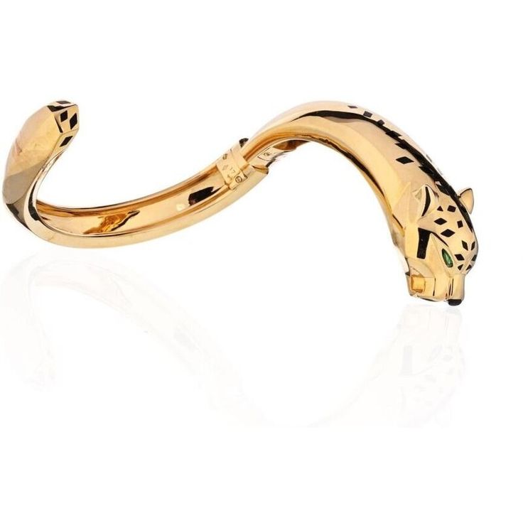 This remarkable Cartier 18K Yellow Gold Panthere Size 17 Bangle Bracelet is a true masterpiece that embodies elegance, strength, and individuality. Crafted with meticulous attention to detail, this hinged bangle showcases the iconic Cartier 'Panthere' design in all its glory. The mesmerizing panther head, set with captivating peridot eyes, an onyx nose, and meticulously hand-applied black lacquer spots, exudes a sense of wild allure and untamed beauty.Wearing this bangle is like wearing a piece Luxury 14k Gold Bangle Bracelet, Luxury White Gold Cartier Bracelet, Cartier Gold Jubilee Bracelet For Wedding, Cartier Yellow Gold Bracelet For Formal Occasions, Cartier Gold Bracelet With Polished Finish For Wedding, Luxury Cartier Bangle As Gift, Luxury Cartier Bangle For Gift, Luxury Cartier Bangle Gift, Cartier Luxury Gold Bracelet With 17 Jewels