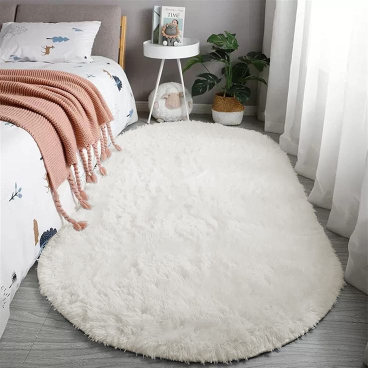 a white rug on the floor in a bedroom