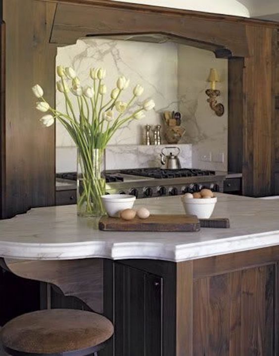 a kitchen with an island and stools in it